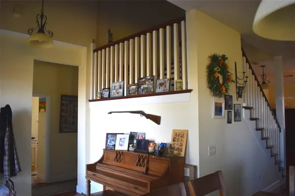 a room with table chairs and wooden floor