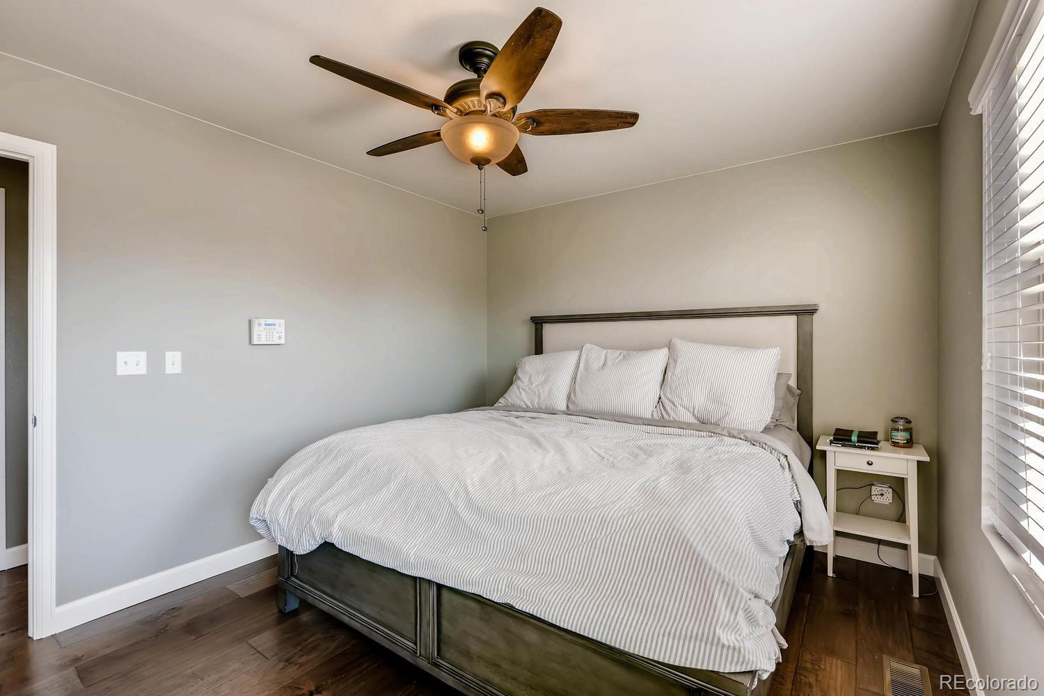 10261 Bellwether Lane Lone Tree, CO 80124 - Photo 11 of 35 a bedroom with a bed and a ceiling fan