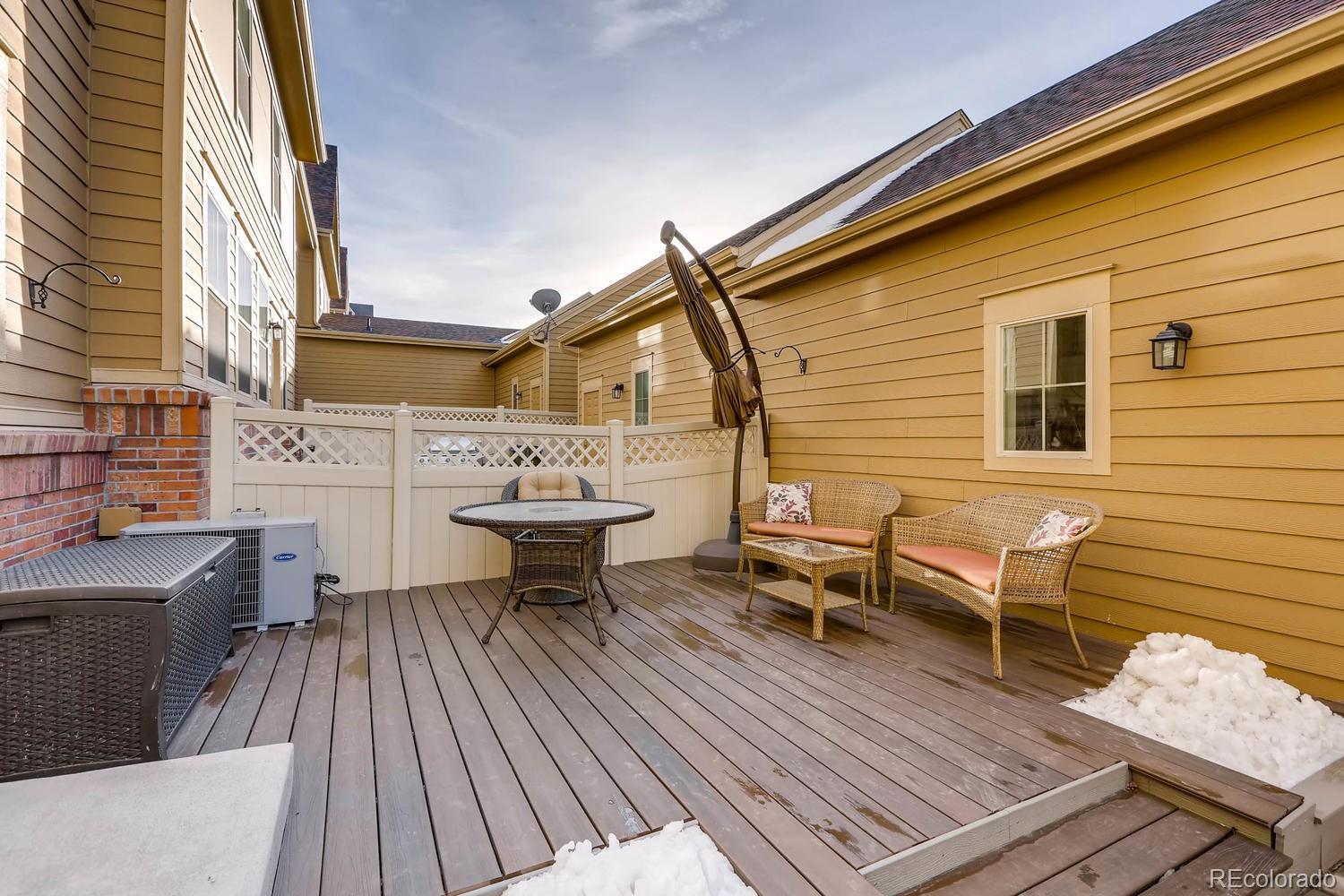 10261 Bellwether Lane Lone Tree, CO 80124 - Photo 22 of 35 a view of a roof deck with table and chairs