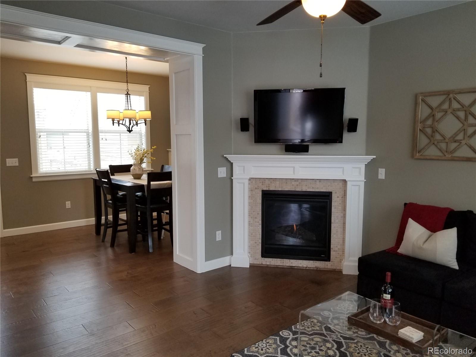 10261 Bellwether Lane Lone Tree, CO 80124 - Photo 7 of 35 a living room with furniture fireplace and flat screen tv