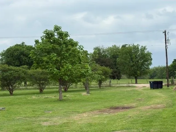 a big yard with lots of green space and trees