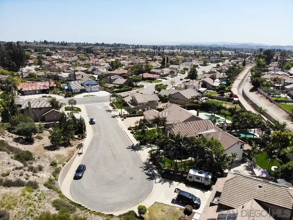 an aerial view of a house with a swimming pool