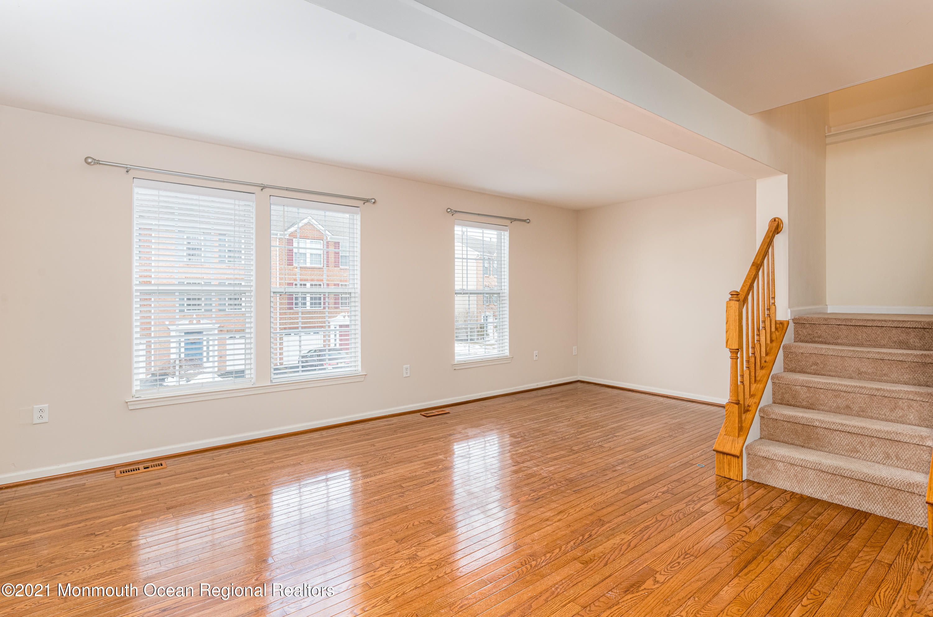 53 Saxton Road Farmingdale, NJ 07727 - Photo 12 of 22 an empty room with wooden floor and windows