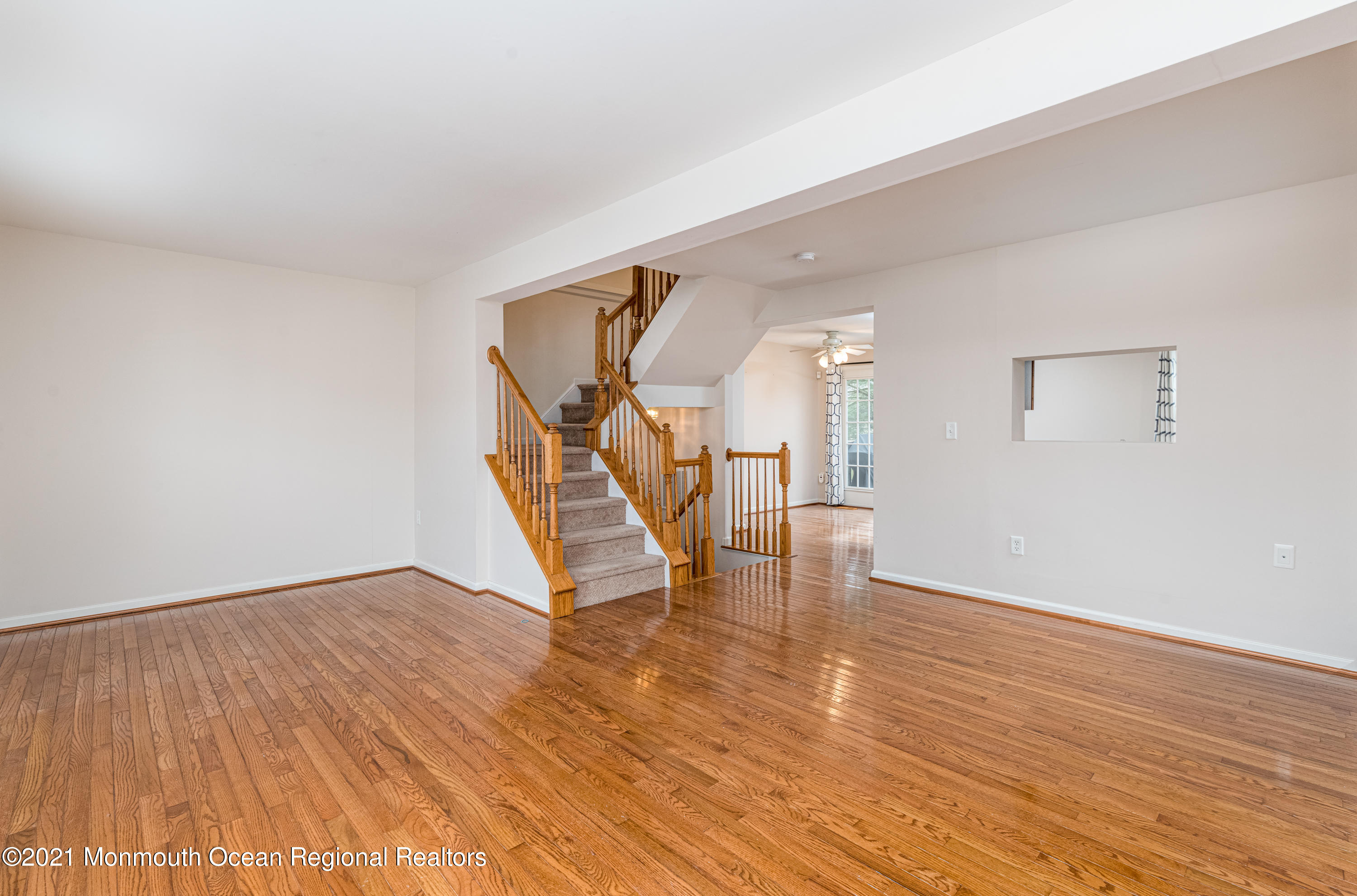 53 Saxton Road Farmingdale, NJ 07727 - Photo 13 of 22 a view of an empty room with wooden floor and a hallway