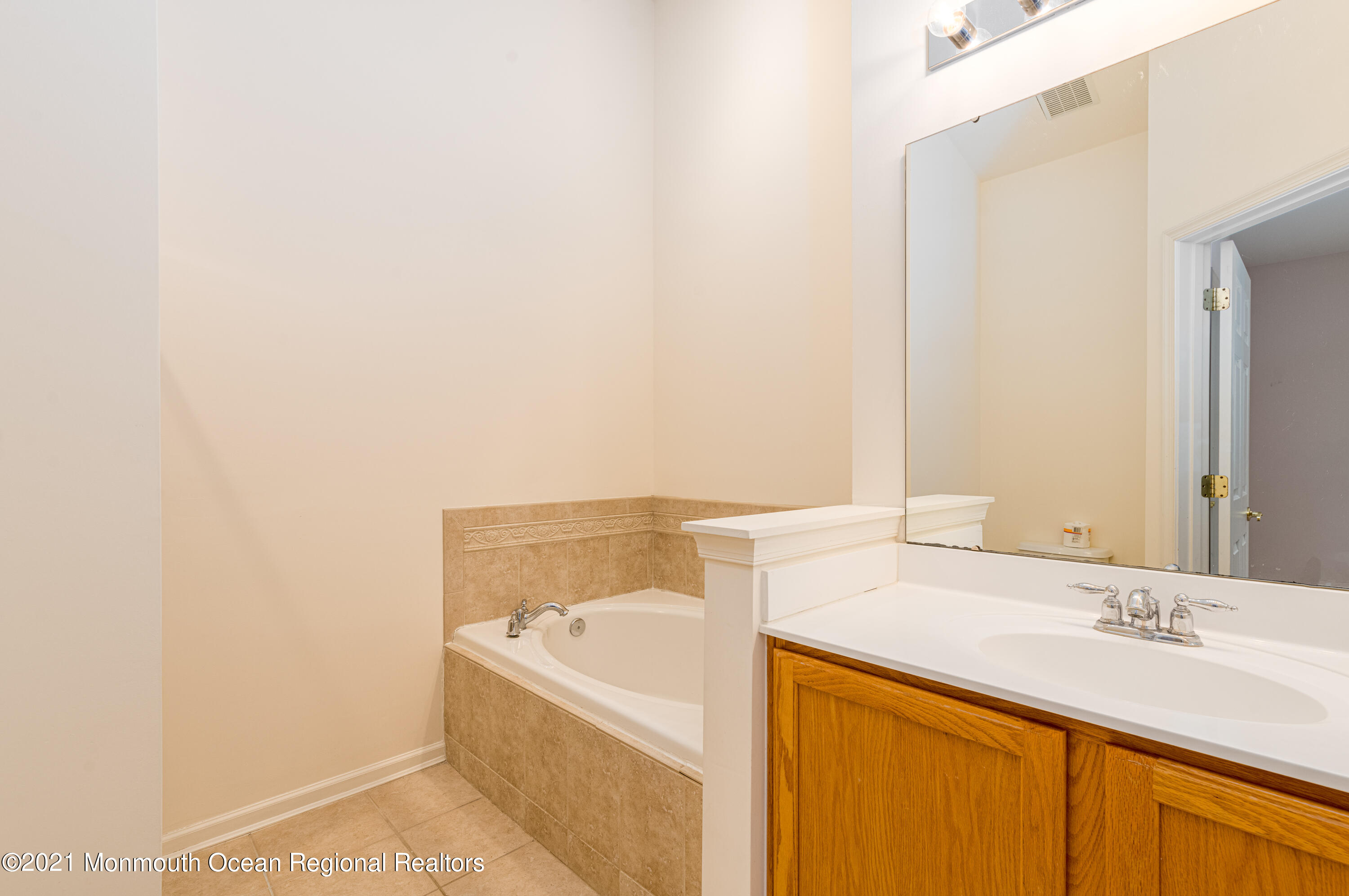 53 Saxton Road Farmingdale, NJ 07727 - Photo 17 of 22 a bathroom with a sink and a bathtub