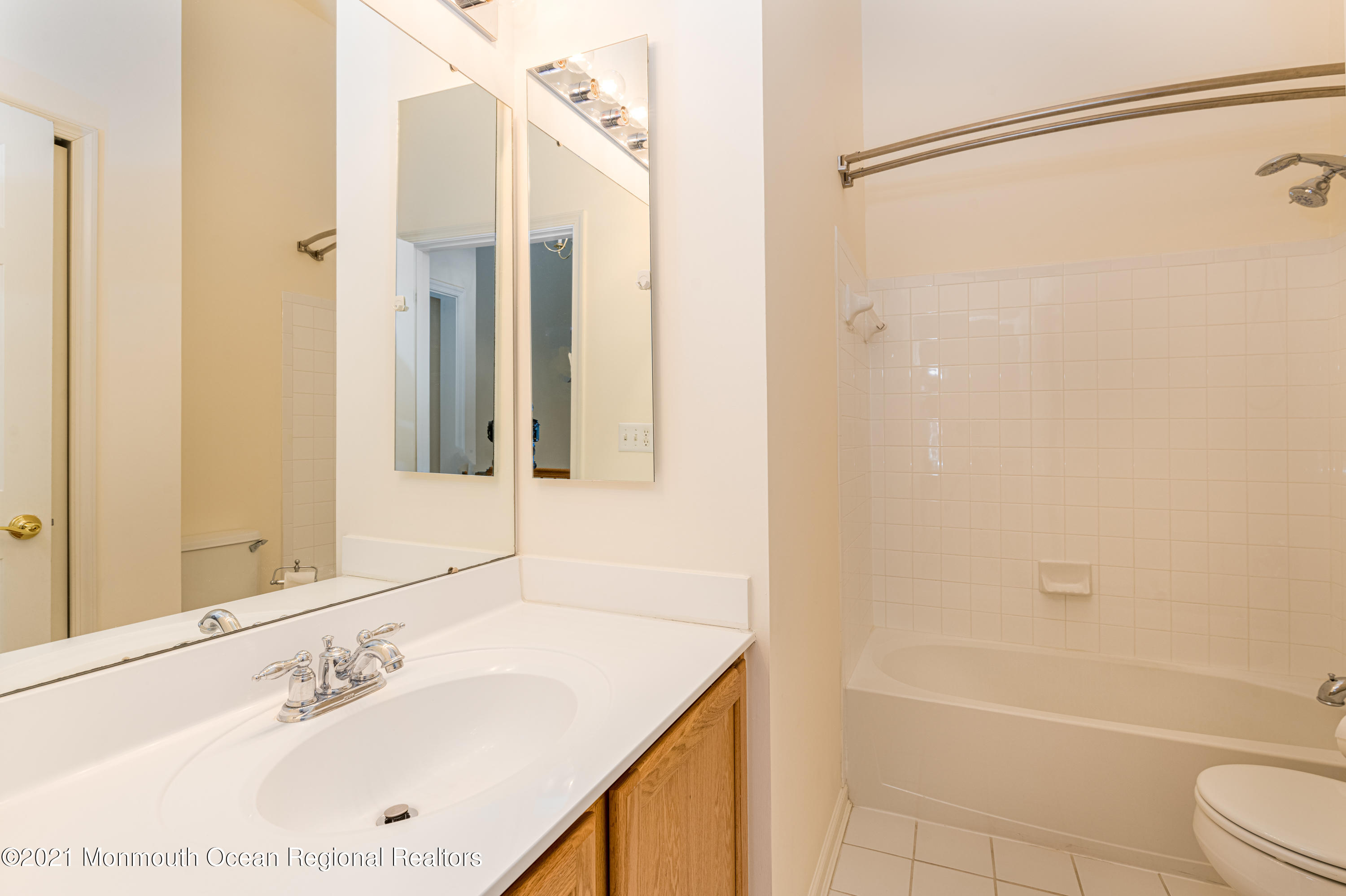 53 Saxton Road Farmingdale, NJ 07727 - Photo 20 of 22 a bathroom with a bathtub a sink and a mirror