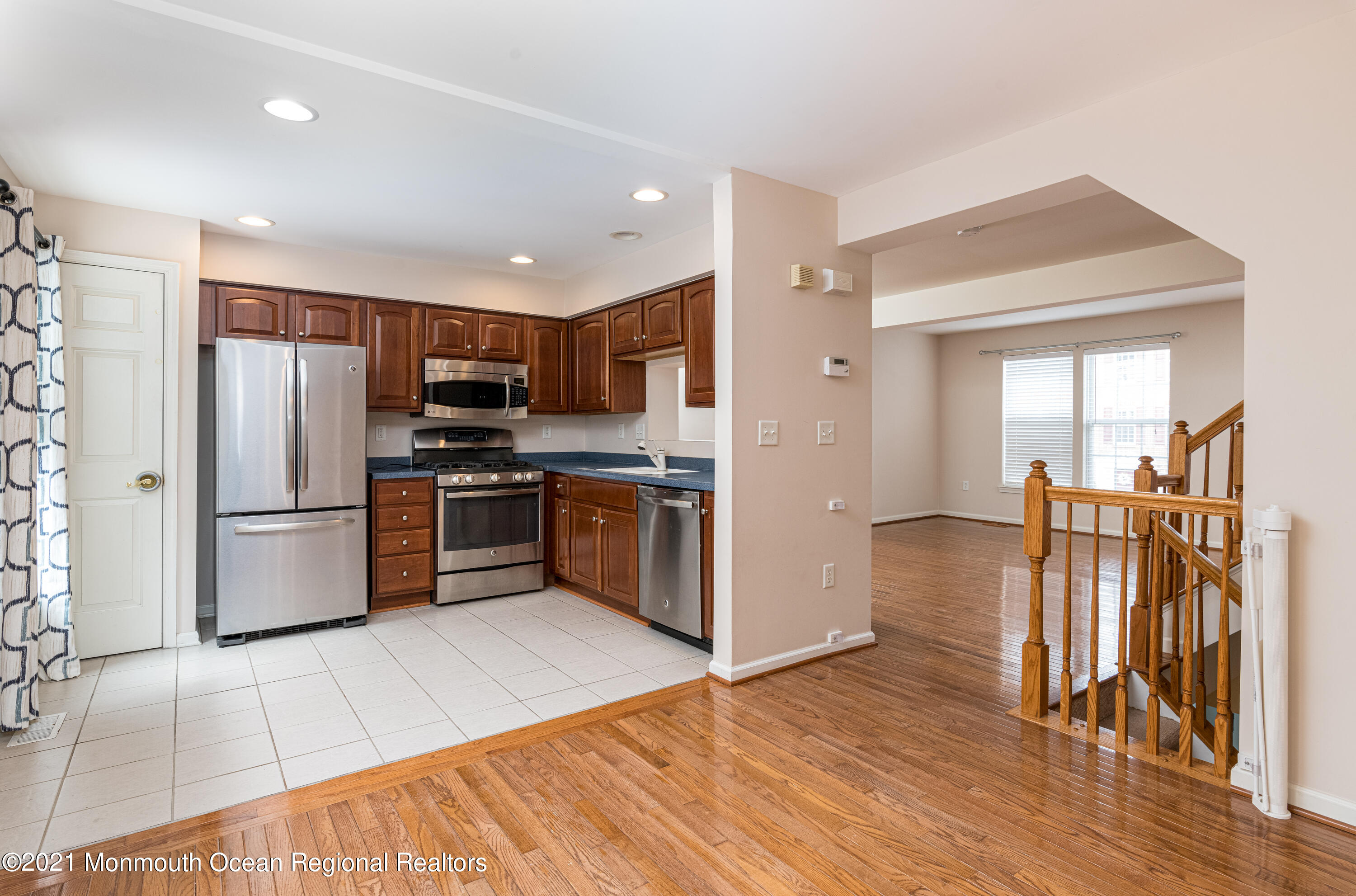 53 Saxton Road Farmingdale, NJ 07727 - Photo 7 of 22 a kitchen with granite countertop a refrigerator and a stove top oven