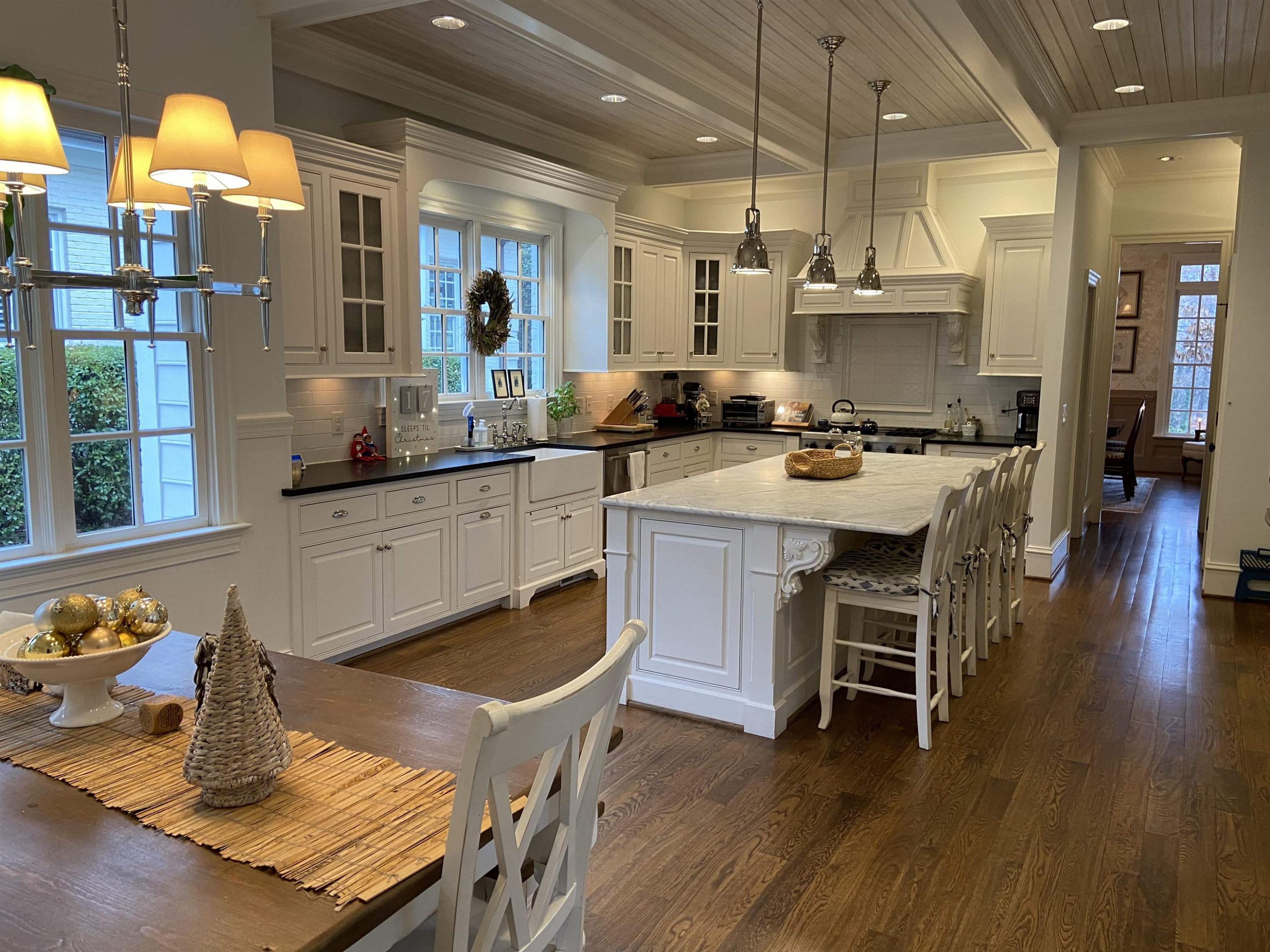 3319 Hampton Road Raleigh, NC 27607 - Photo 6 of 18 a kitchen with stainless steel appliances kitchen island granite countertop a table chairs sink and cabinets