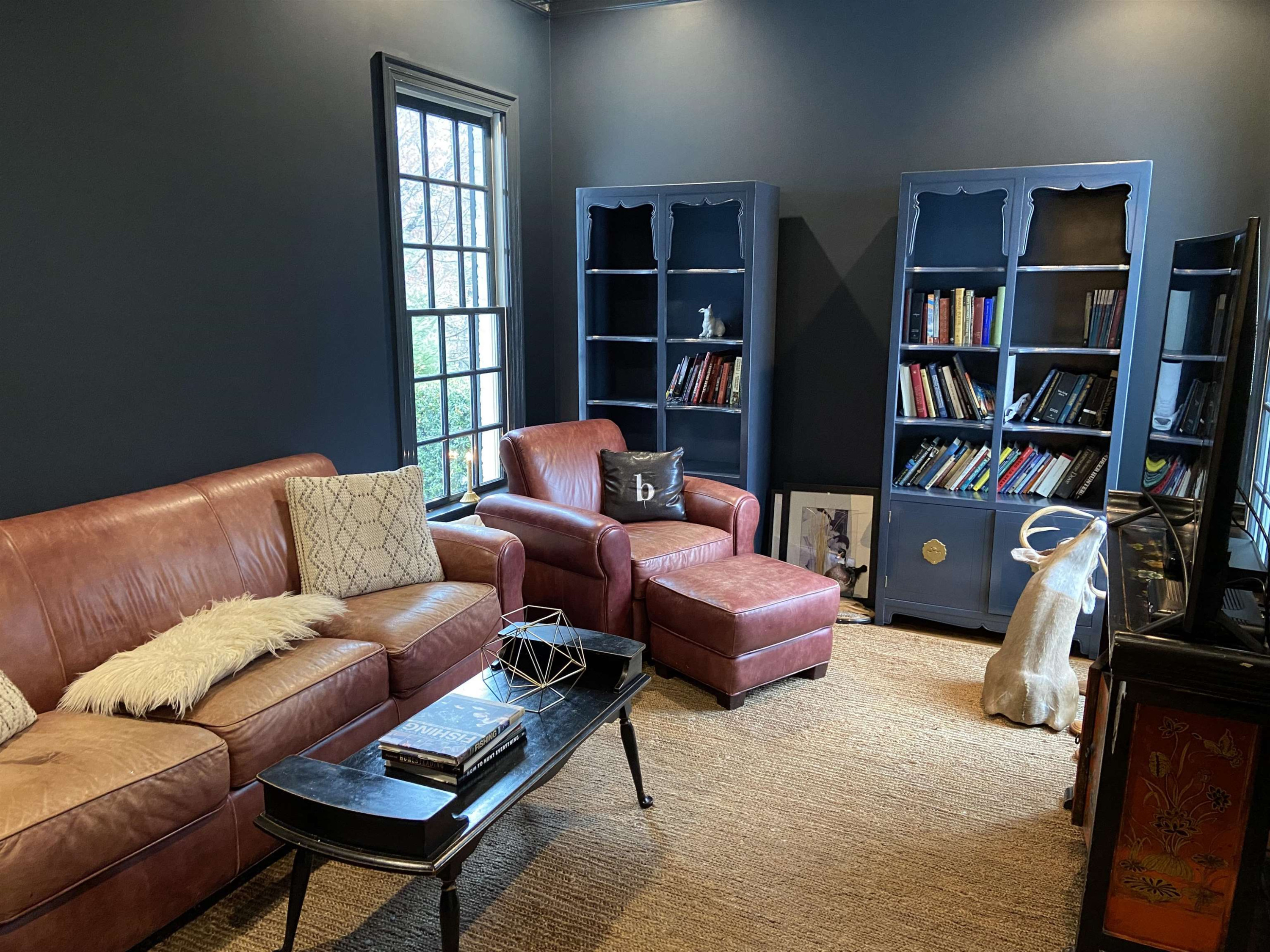 3319 Hampton Road Raleigh, NC 27607 - Photo 10 of 18 a living room with furniture a book shelf and a window