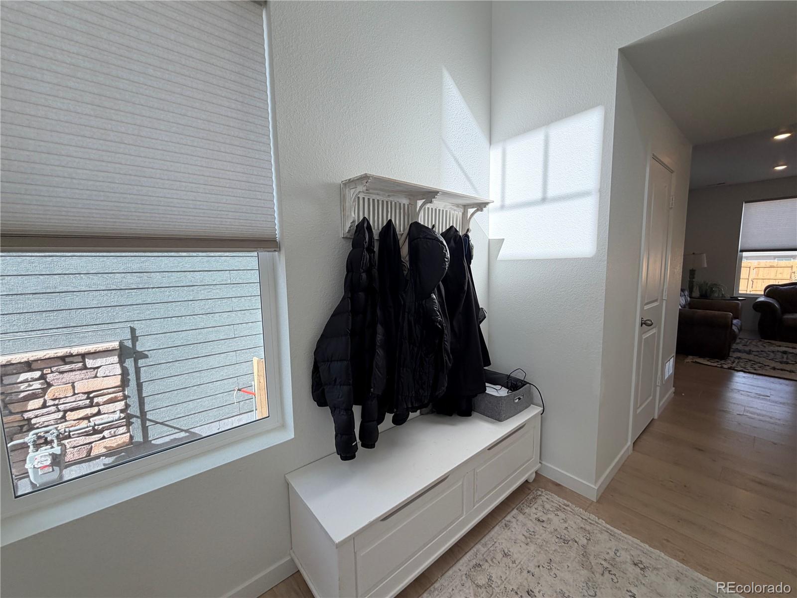 755 Yankee Boy Loop Elizabeth, CO 80107 - Photo 11 of 31 a view of hallway with furniture and a wooden floor