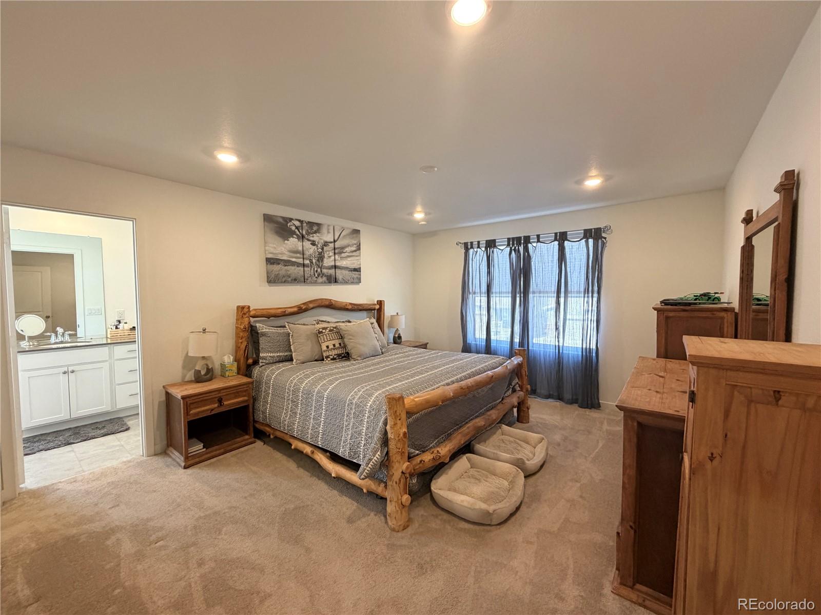 755 Yankee Boy Loop Elizabeth, CO 80107 - Photo 13 of 31 a spacious bedroom with a bed a couch and dresser