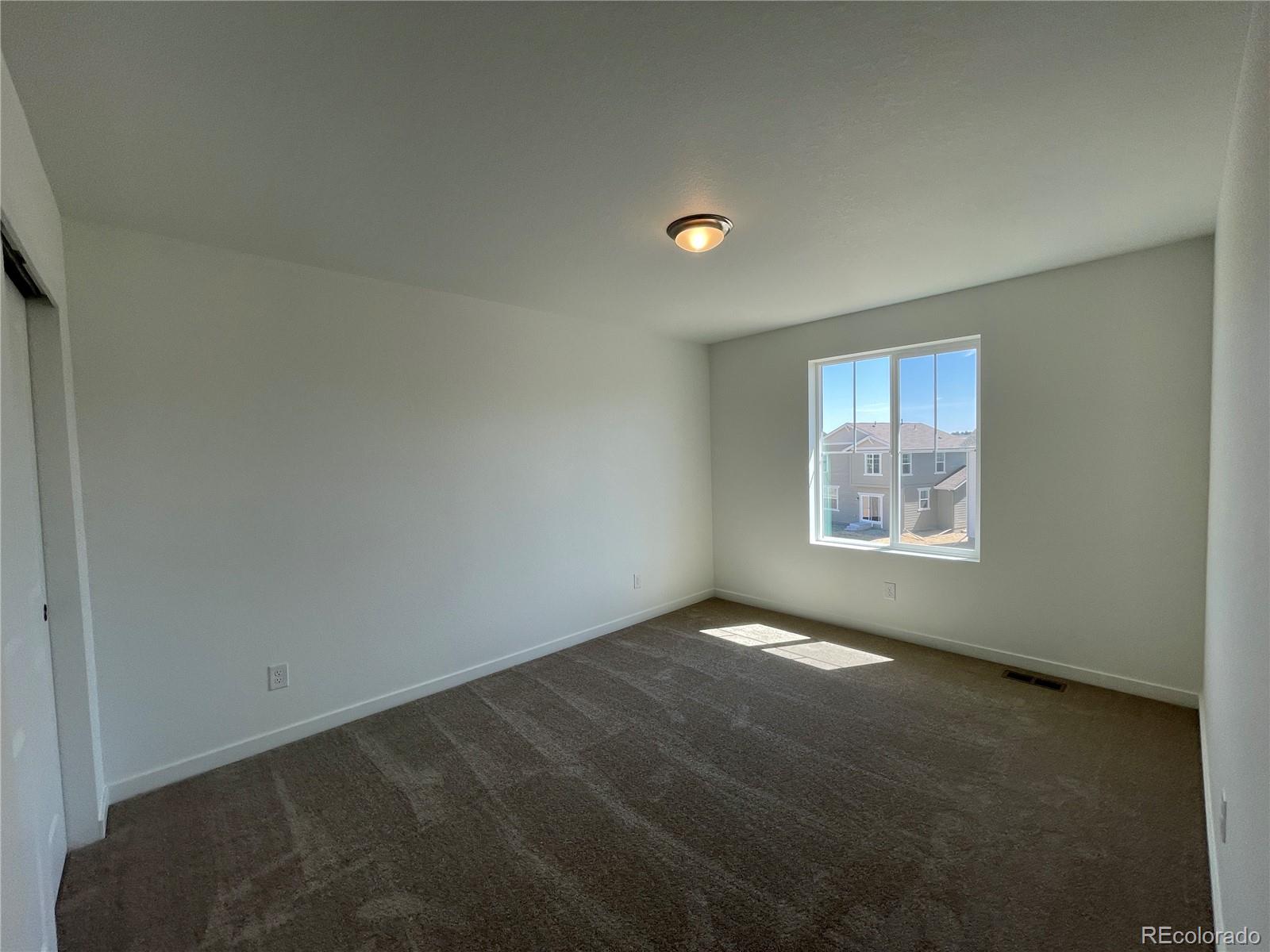 755 Yankee Boy Loop Elizabeth, CO 80107 - Photo 18 of 31 an empty room with a window