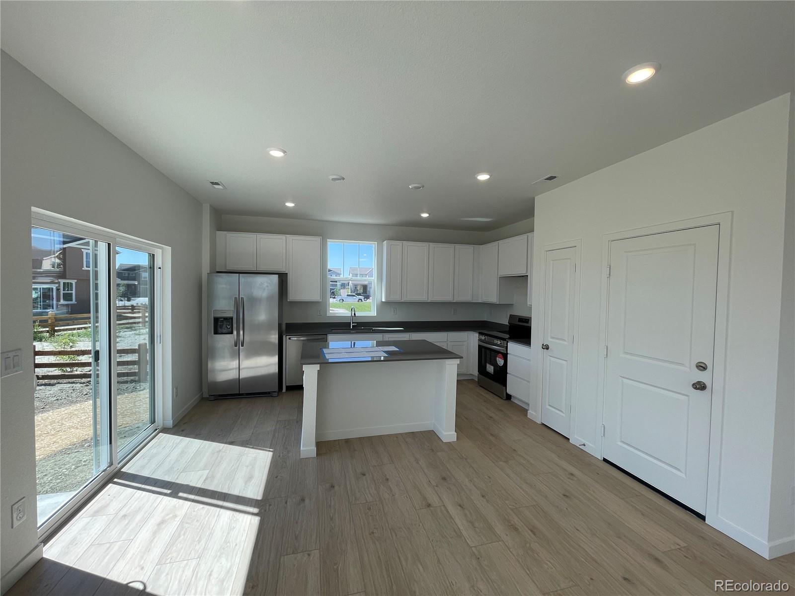 755 Yankee Boy Loop Elizabeth, CO 80107 - Photo 2 of 31 a kitchen with a refrigerator and a counter top space