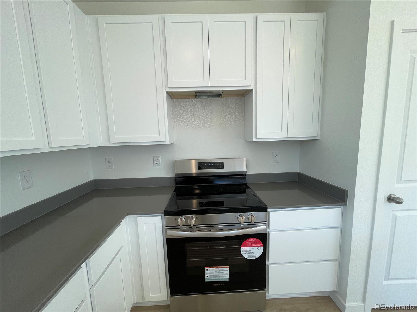 755 Yankee Boy Loop Elizabeth, CO 80107 - Photo 5 of 31 a kitchen with microwave cabinets and stove top oven