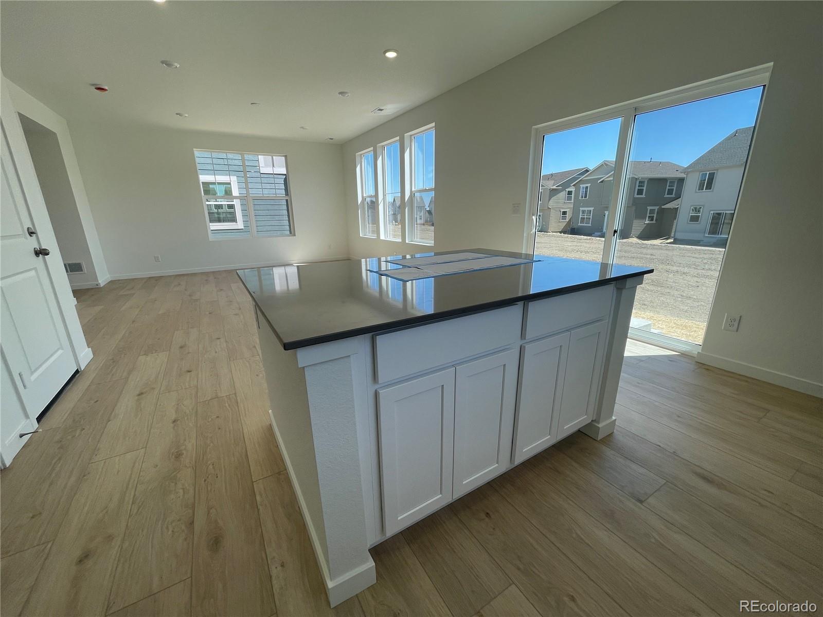 755 Yankee Boy Loop Elizabeth, CO 80107 - Photo 7 of 31 a kitchen with granite countertop wooden floors a sink and a window