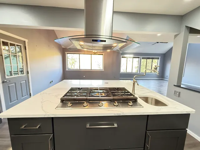 a stove top oven sitting inside of a kitchen