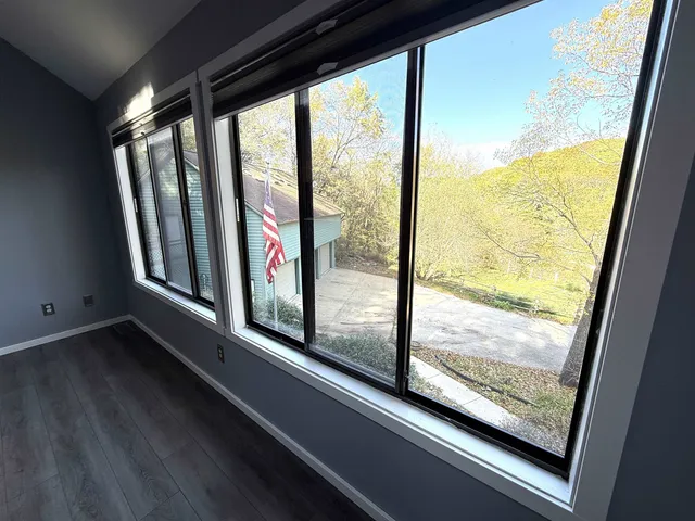 a view of a room with wooden floor and furniture