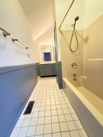 a bathroom with a bathtub and a shower