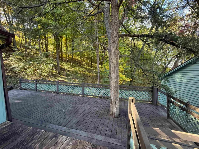 a view of a wooden deck with a yard