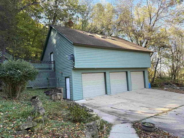 a backyard of a house with large trees and brick walls