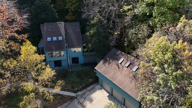 an aerial view of a house with a yard basket ball court and outdoor seating