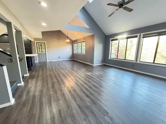 wooden floor in an empty room with a window