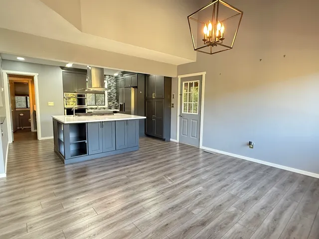 an open kitchen with a chandelier