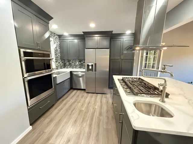 a kitchen with refrigerator and stove