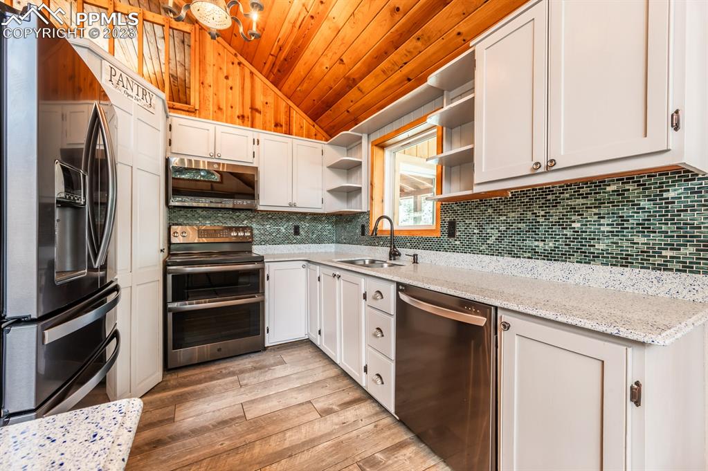 38 Wetmore Drive Rye, CO 81069 - Photo 13 of 49 a kitchen with stainless steel appliances kitchen island granite countertop a refrigerator and a stove top oven