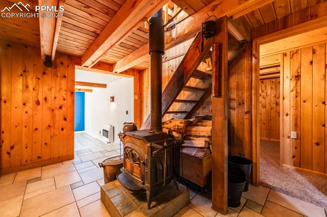 a view of a hallway with wooden walls