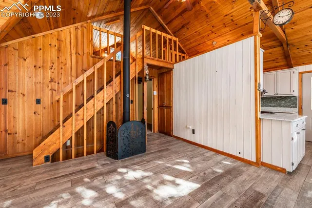 a kitchen with stainless steel appliances kitchen island granite countertop a refrigerator and a stove top oven