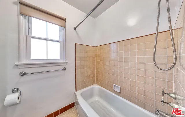 a bathroom with a bath tub and a shower