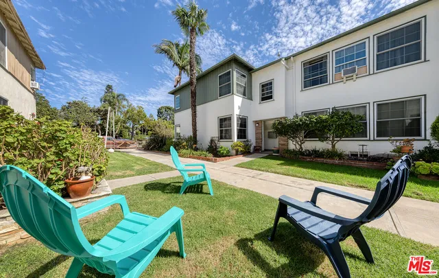 a view of a house with backyard sitting area and swimming pool