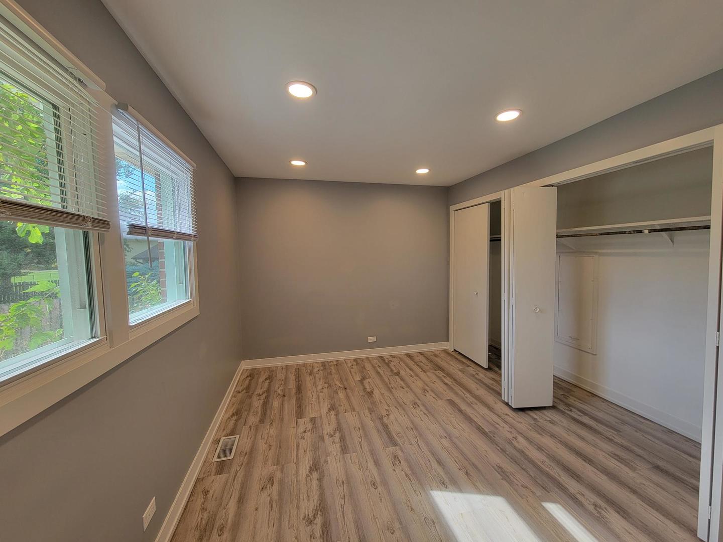 1001 East Callero Circle, Unit 1 Mount Prospect, IL 60056 - Photo 10 of 14 an empty room with wooden floor and windows
