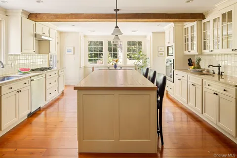 a kitchen with stainless steel appliances a stove a sink a microwave and cabinets