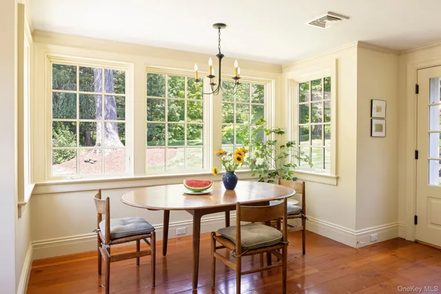 a front view of a houses with yard and green space
