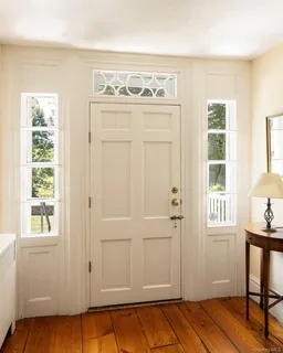 a view of a livingroom with wooden floor and a window