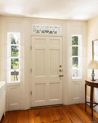 a view of a livingroom with wooden floor and a window
