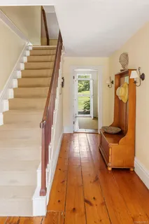 a view of entryway and hall with wooden floor