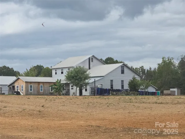 a car parked in front of a white house