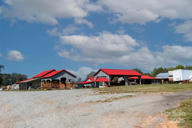 an aerial view of residential houses with outdoor space and pool