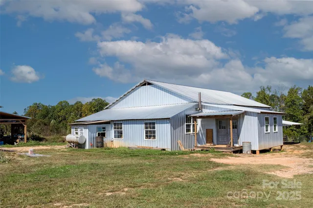 an aerial view of a house with a yard basket ball court and outdoor seating