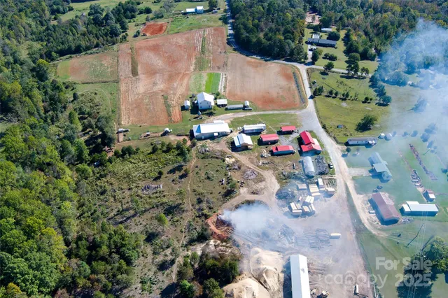 a backyard of a house with wooden fence and a barbeque