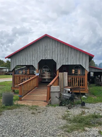 a view of a house with a yard and wooden fence