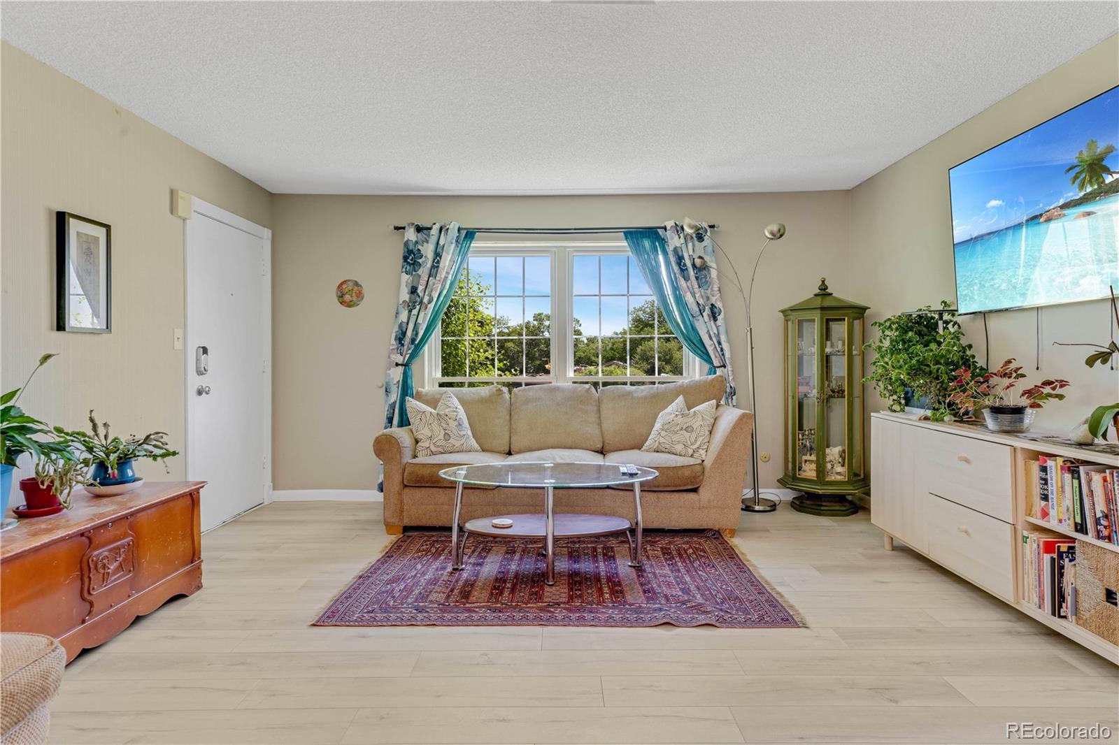 3855 South Monaco Street, Unit 203 Denver, CO 80237 - Photo 1 of 26 a living room with furniture rug and wooden floor