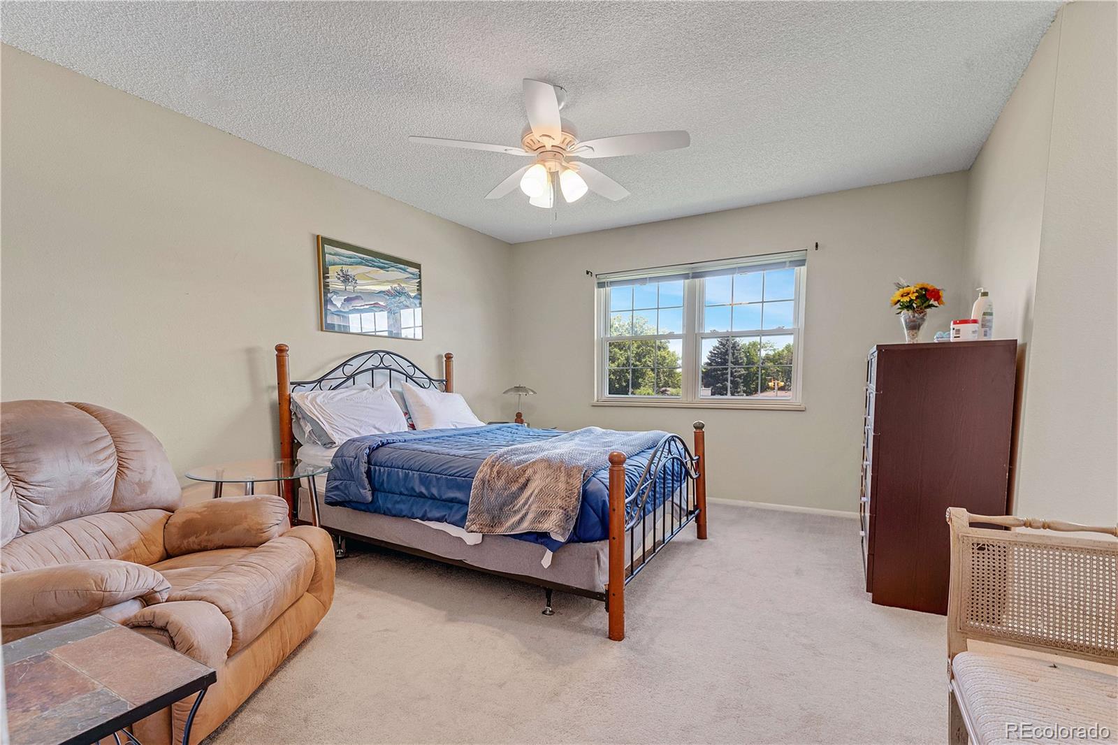 3855 South Monaco Street, Unit 203 Denver, CO 80237 - Photo 11 of 26 a bedroom with a bed couch and window