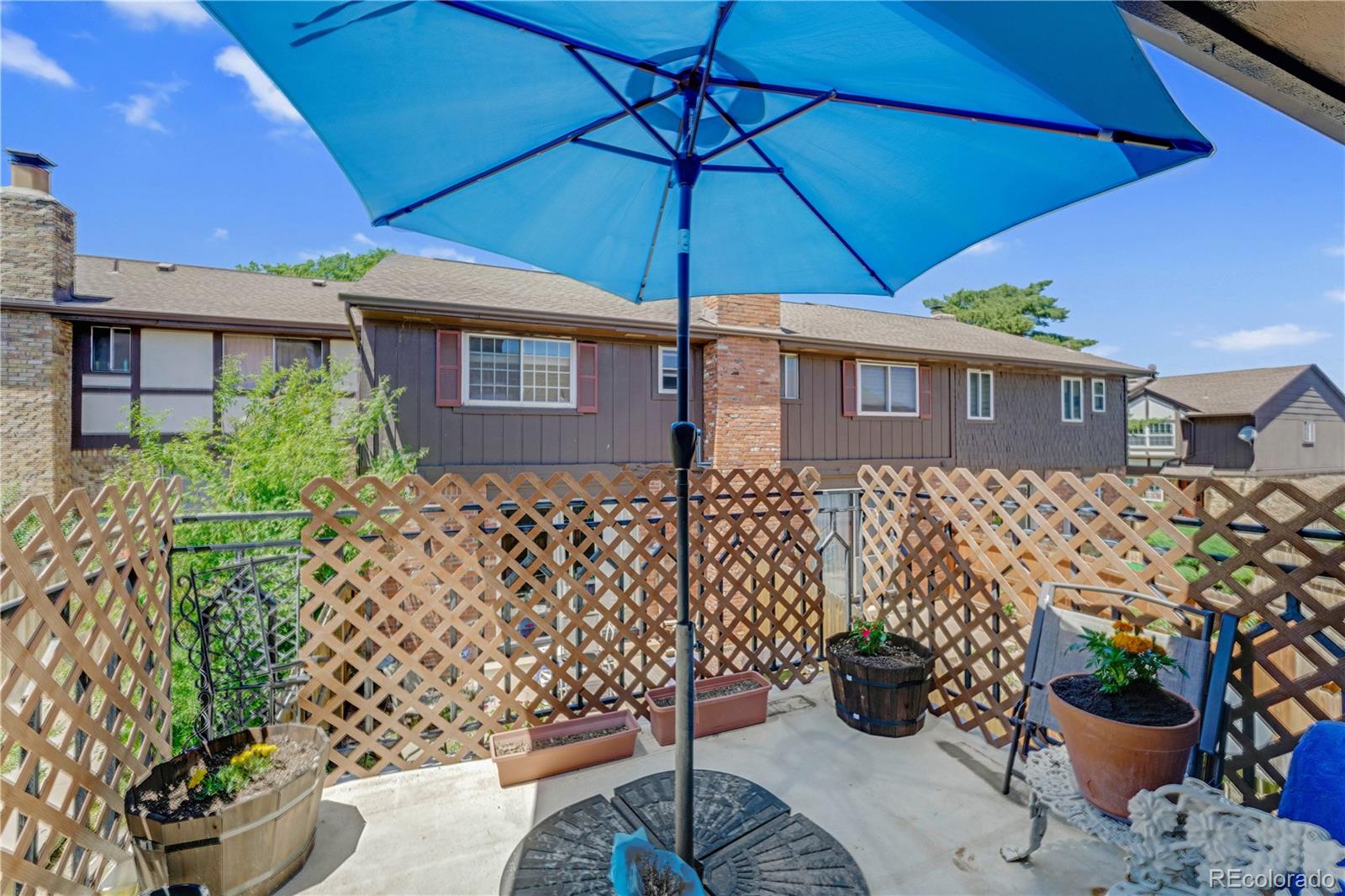 3855 South Monaco Street, Unit 203 Denver, CO 80237 - Photo 15 of 26 a view of a backyard with potted plants