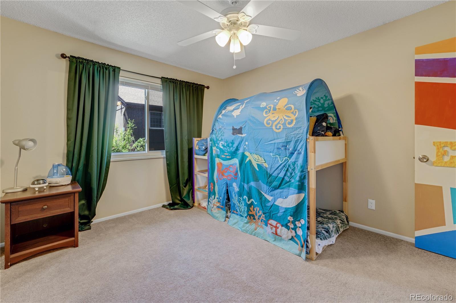 3855 South Monaco Street, Unit 203 Denver, CO 80237 - Photo 16 of 26 a view of an empty room with window and furniture