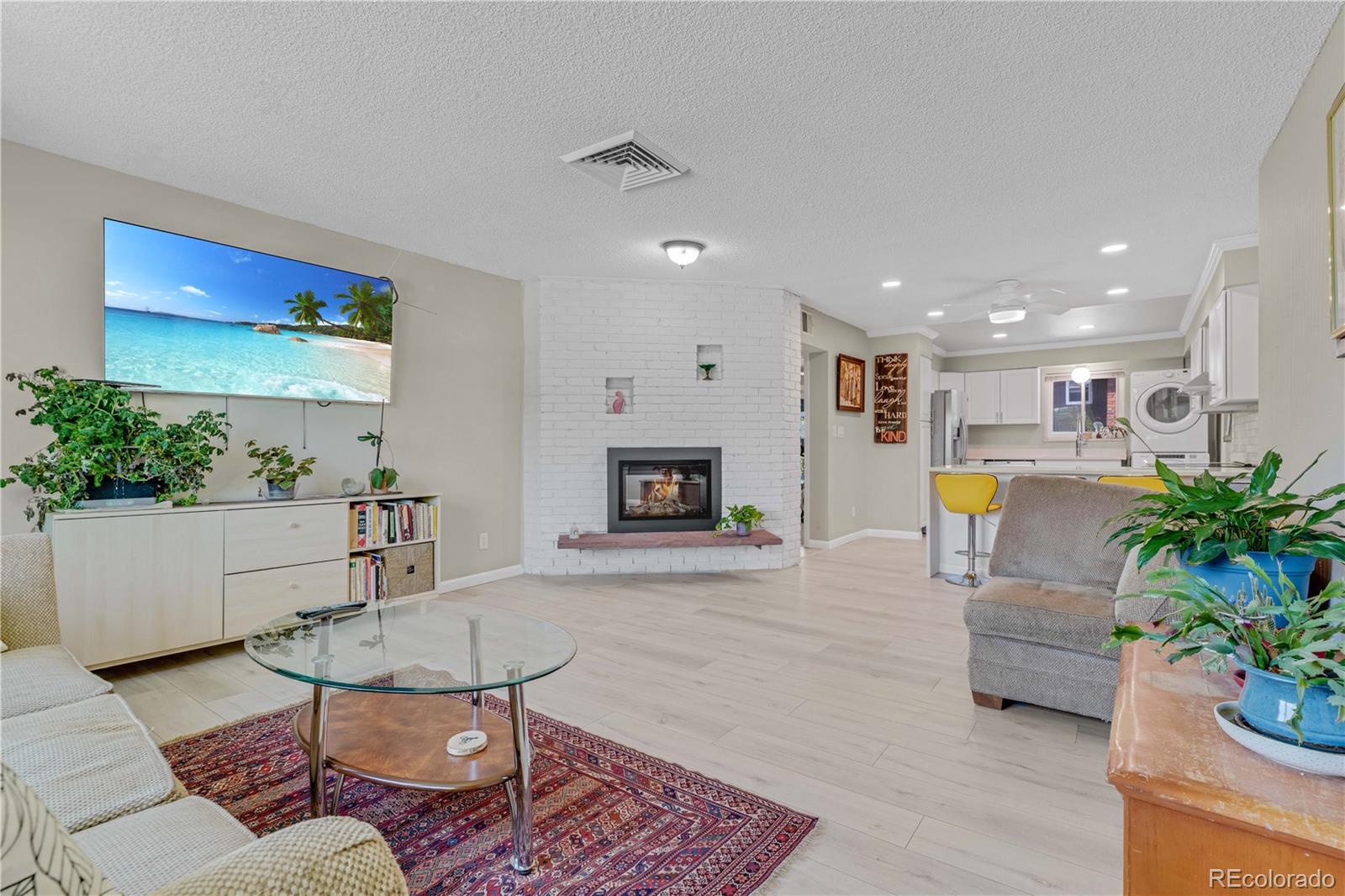 3855 South Monaco Street, Unit 203 Denver, CO 80237 - Photo 2 of 26 a living room with furniture and a fireplace