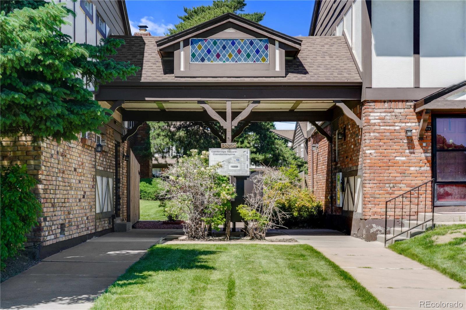 3855 South Monaco Street, Unit 203 Denver, CO 80237 - Photo 21 of 26 a front view of a house with a garden
